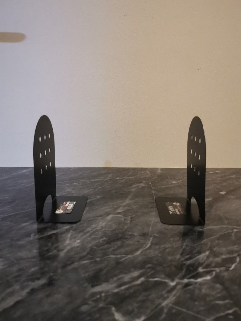 Mono Chrom Steel Bookend (Category: Announcements) located in Singapore. Submitted by hibiscus123456 (Listing ID 1375576016, Image 2). Description: This is a Bookend made of steel. It is in almost new condition. The Bookend has a unique design with multiple holes. It is a great addition to any home or office. The Bookend is sturdy and can hold a variety of books and other items. The Bookend is a great way to organize your books and other items..