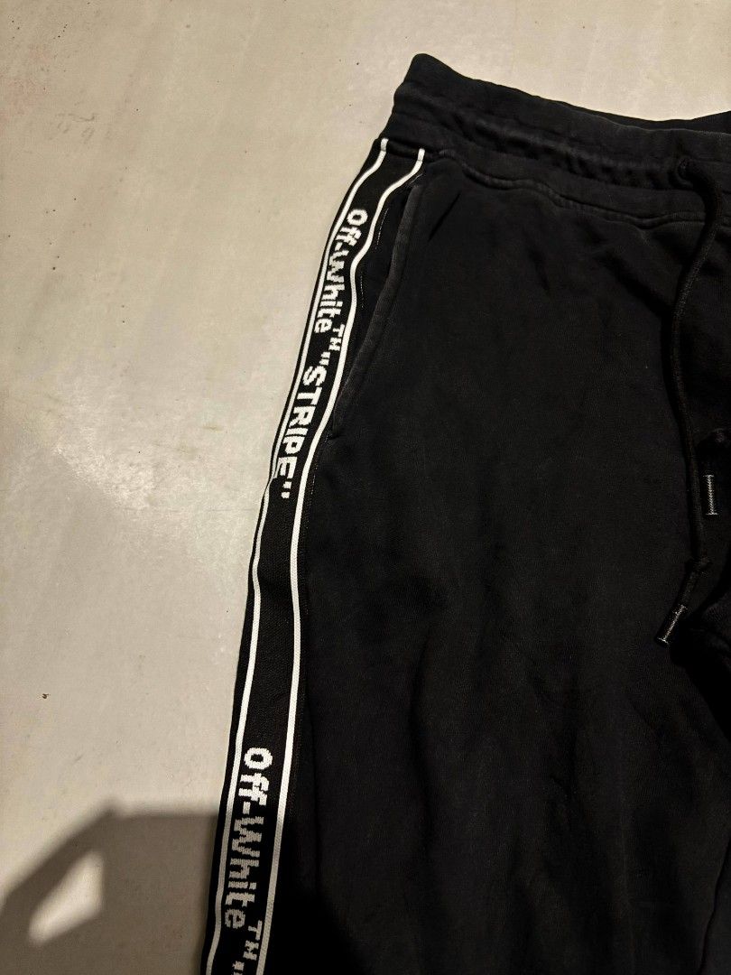Off- White Side Tape Jogger Pants (Category: Joggers) located in Bauan. Submitted by onetwothrift2 (Listing ID 1375485140, Image 2). Description: Off- White Side Tape Jogger Pants Waist: 31-34 Length: 37.5 Color rate: 9/10 Excellent condition No issue.