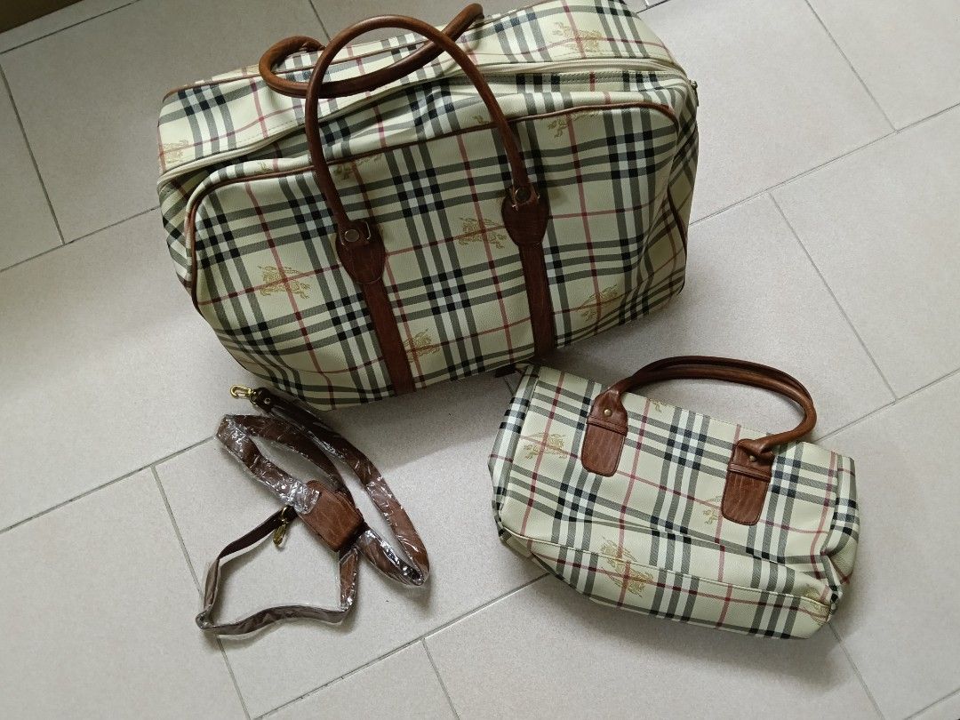Burberry travel bags (Category: Bags & Wallets) located in Singapore. Submitted by mattehs (Listing ID 1375667571, Image 1). Description: 80 for everything. some wears and tears on the leather. not real burberry.
