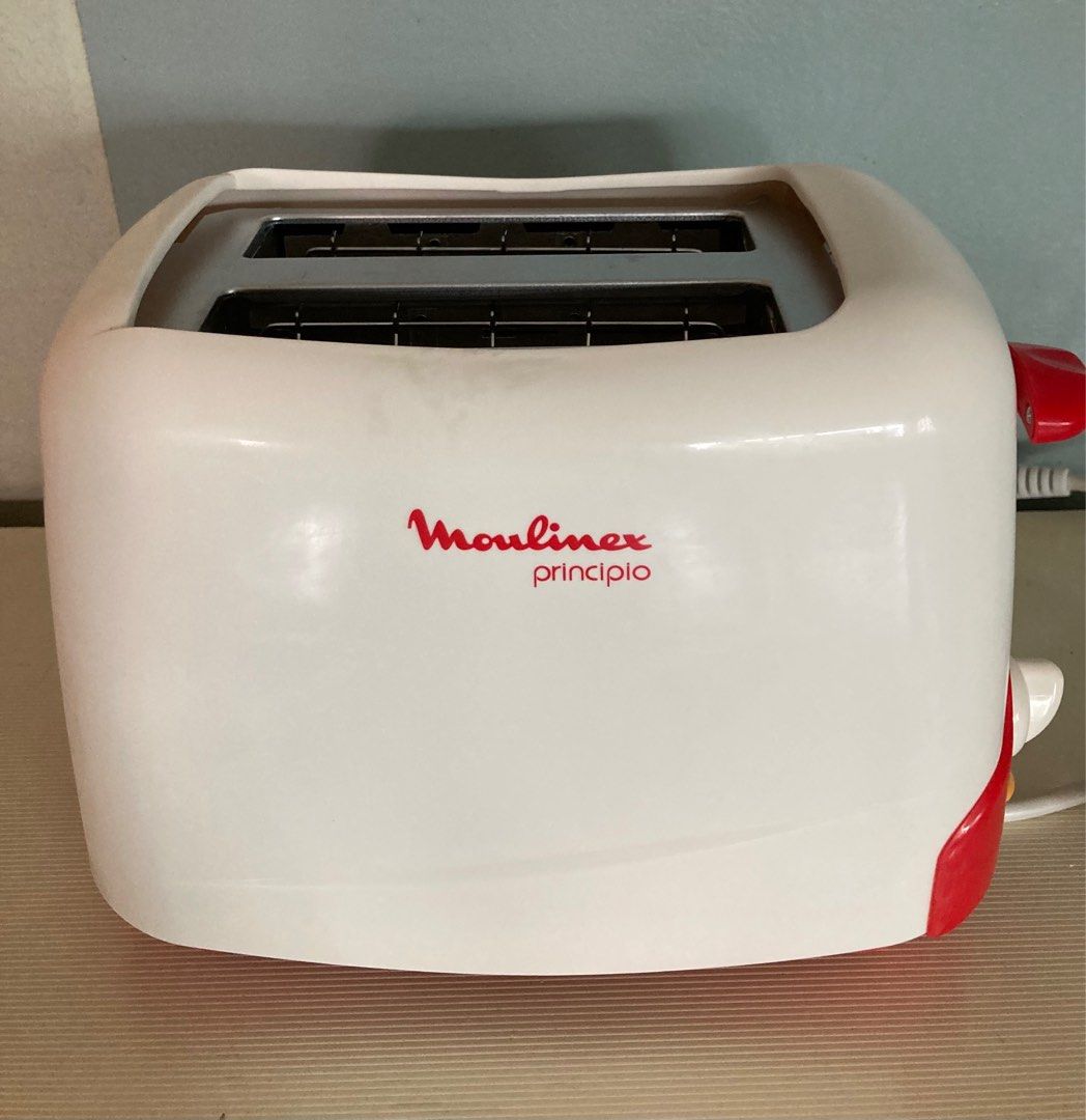 Moulinex Principio Bread Toaster (Category: Ovens & Toasters) located in Manila. Submitted by daddythrifter (Listing ID 1375751915, Image 1). Description: Two slot, 1-6 browning settings, cancel button, high lift, removable crumb tray Color: white Length: 9” Height 7.5” Issue: slight stain due to storage as shown in last pic.