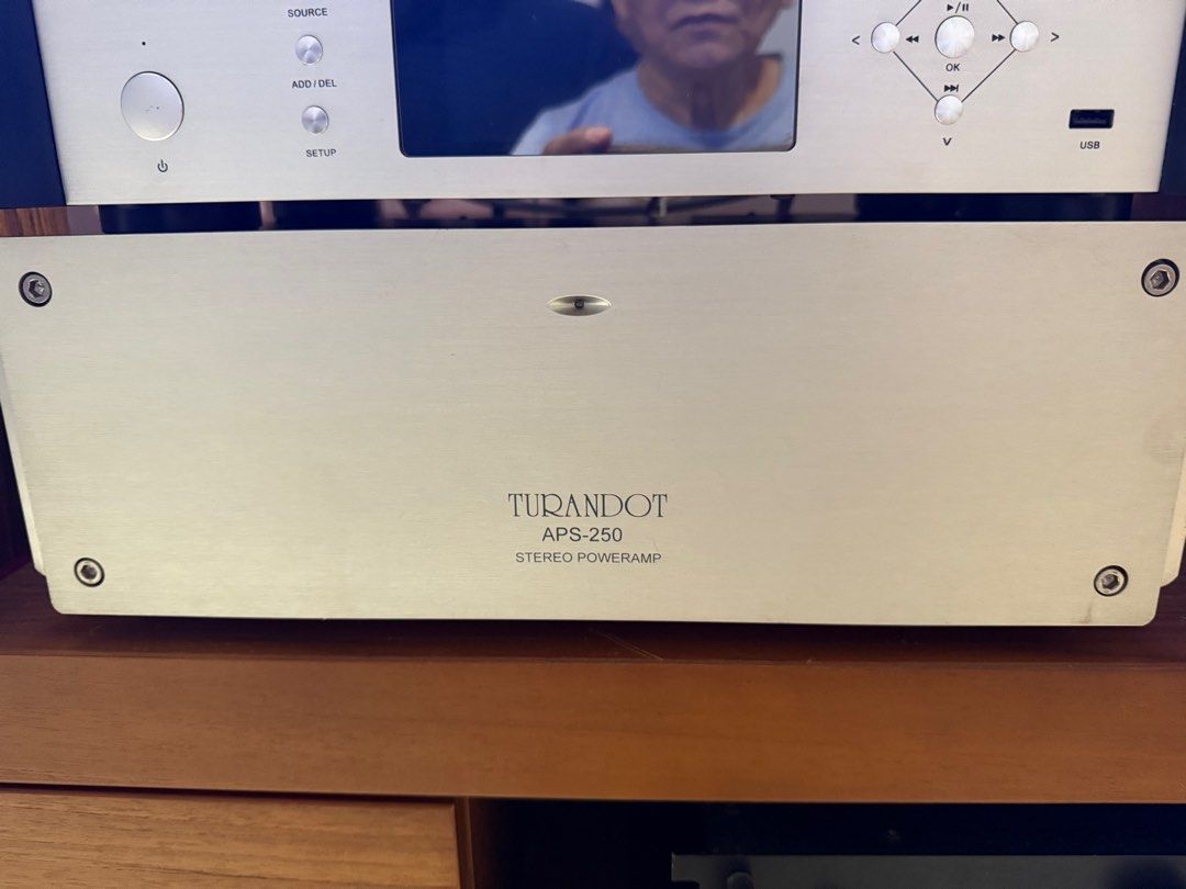 Turandot APS-250 Stereo Poweramp (Category: Soundbars, Speakers & Amplifiers) located in Singapore. Submitted by tb1401 (Listing ID 1375768108, Image 1). Description: Turandot APS-250 Stereo Poweramp for sale. Features include a power on switch and various input/output connections. The unit is silver-colored with a sleek design. It appears to be in good condition. Please examine the images for details. Open to trade. .