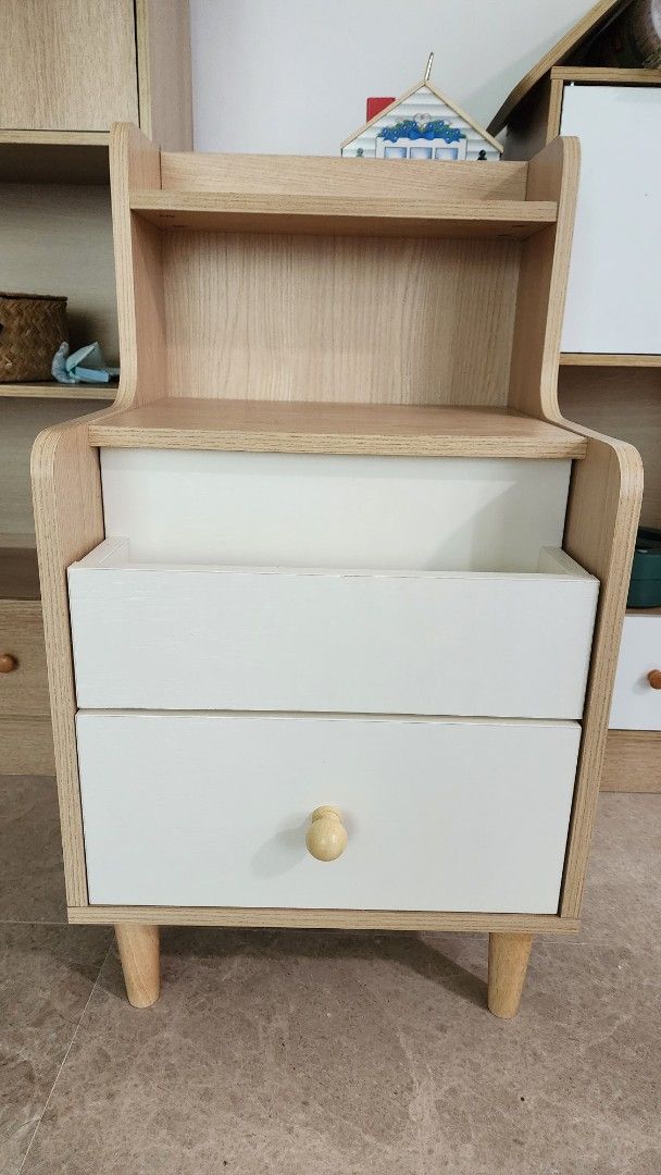 Bedside Table (Category: Shelves, Cabinets & Racks) located in Singapore. Submitted by treasured_gems (Listing ID 1372489046, Image 2). Description: Like new side table book shelf in perfect condition. Many useful drawers and practical. Nice natural beige and white colour. Seee images for size. Retails over $130 brand new, priced to sell. Only 1 available. Pick up Newton PM.
