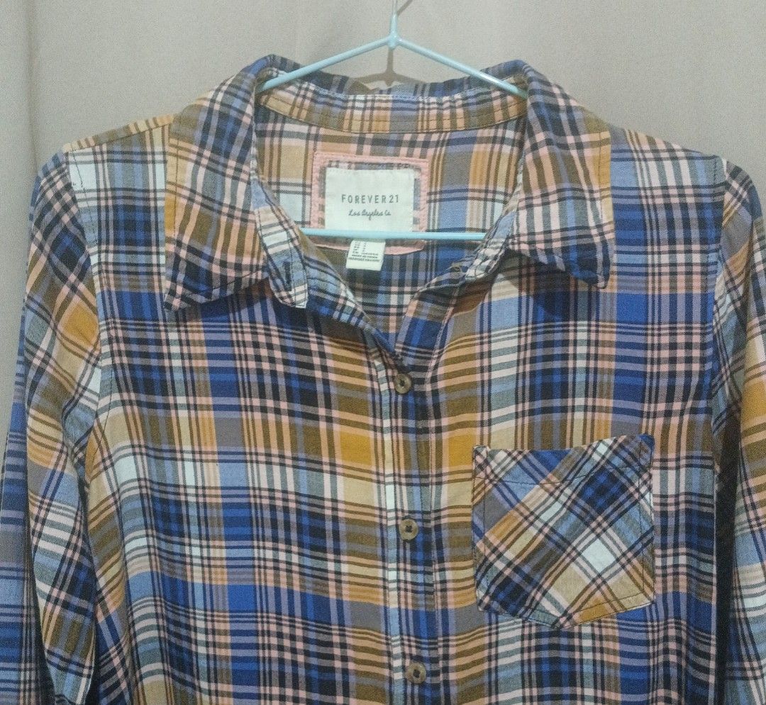 FOREVER21 Blue & Orange Checkered Longsleeves Polo (Category: Longsleeves) located in Tarlac. Submitted by animerika565 (Listing ID 1371751964, Image 1). Description: RFS: Decluttering & its not my size anymore, not ukay size on tag : S H : 27 inches W from front : 21 inches Shoulders : 14 inches Sleeves: 24 inches flaw: loose threads MOP: Gcash delivery: J&T.