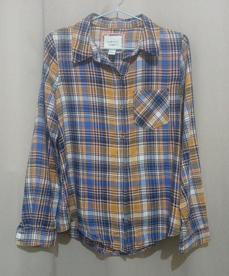 FOREVER21 Blue & Orange Checkered Longsleeves Polo (Category: Longsleeves) located in Tarlac. Submitted by animerika565 (Listing ID 1371751964, Image 2). Description: RFS: Decluttering & its not my size anymore, not ukay size on tag : S H : 27 inches W from front : 21 inches Shoulders : 14 inches Sleeves: 24 inches flaw: loose threads MOP: Gcash delivery: J&T.