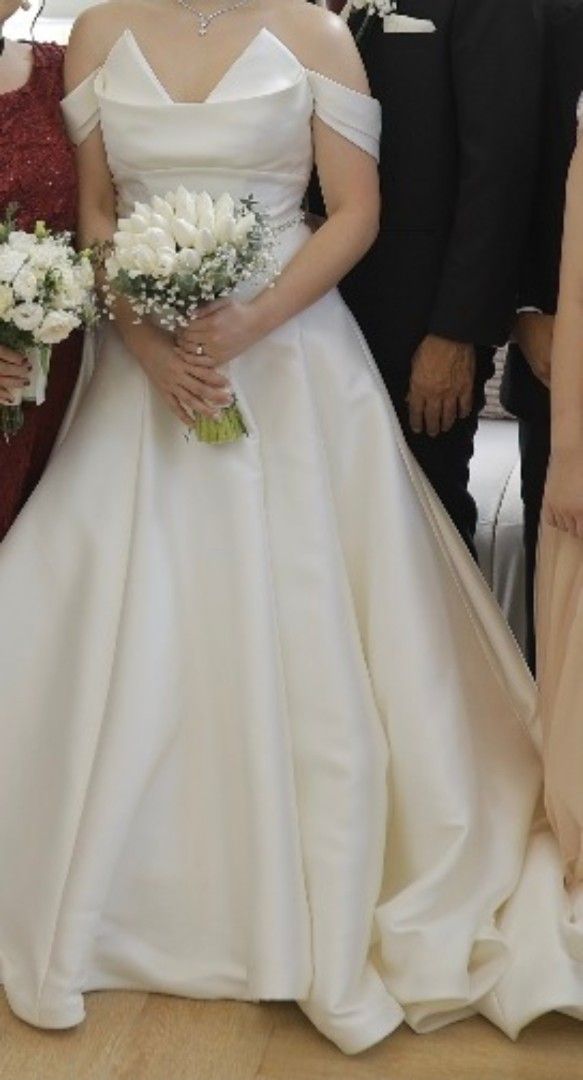 Ivory & White Wedding Gown (Daphne) (Category: Evening dresses & gowns) located in Makati City. Submitted by ClothesAndStuff (Listing ID 1372607365, Image 2). Description: Customized Daphne Bridal Gown Original Value: PHP 53,000 Description: This timeless and elegant ivory bridal gown, crafted from premium Duchess Satin, exudes sophistication and grace. This minimalist design is elevated by a stunning silver glass crystal belt and a full-covered 