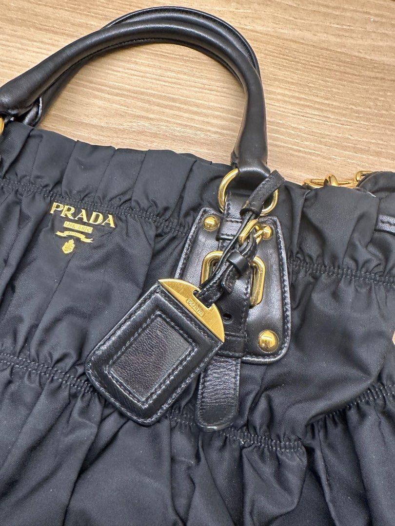 Authentic PR*DA Tessuto Gaufre (Category: Luxury Bags & Wallets) located in Pasig City. Submitted by luckybunch (Listing ID 1375912856, Image 3). Description: ✨ Prada Tessuto Gaufre Ruched Nylon Bag – Black ✨ Classic and timeless Prada piece from 2010 💼 Lightweight, spacious, and perfect for everyday use 🖤 Details: • Authentic Prada Tessuto Gaufre nylon • Color: Nero (black) with gold hardware • Comes with original card + dust bag • With detach