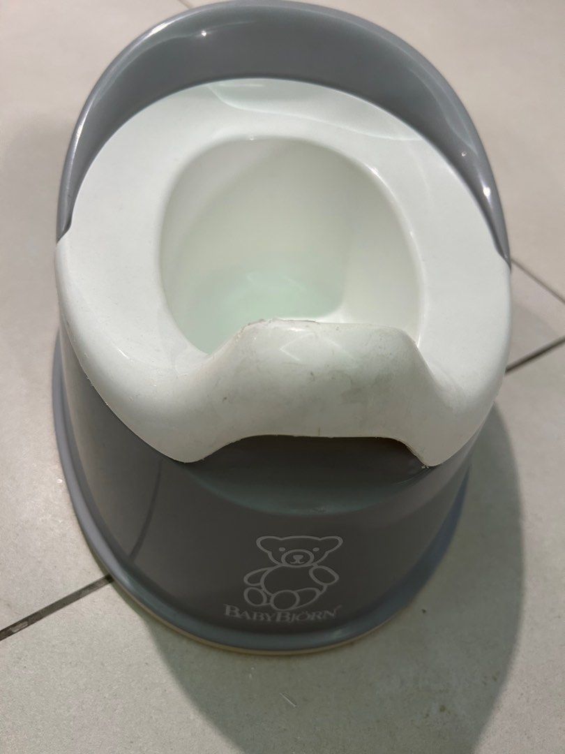 BabyBjorn Potty Training Toilet (Category: Toilet Training) located in Singapore. Submitted by novel_lemon (Listing ID 1375961749, Image 2). Description: Two BabyBjorn potty training toilets available. $15 each. One is grey and the other is red. Both feature a white inner potty and a cute teddy bear logo. Suitable for toddlers learning to use the toilet. Easy to clean and maintain..
