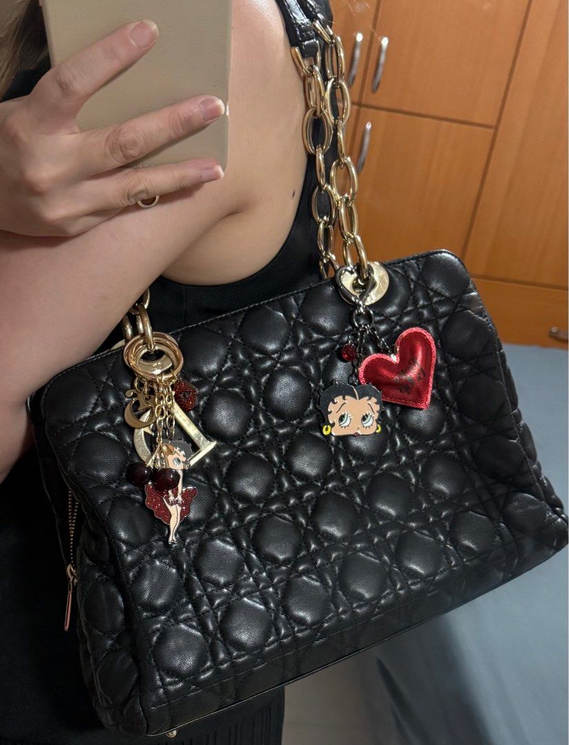 Dior Small Lambskin Cannage Soft Zipped Shopping Tote Bag (Category: Bags & Wallets) located in Singapore. Submitted by sweetpotato99909 (Listing ID 1371964350, Image 3). Description: Classic black quilted leather bag with gold chain detailing. The bag has a double zipper closure and a charm with the Dior logo. Perfect for everyday use or a special occasion. Length 31 cm Width 12 cm Height 23 cm Handle Drop 22.5 cm.