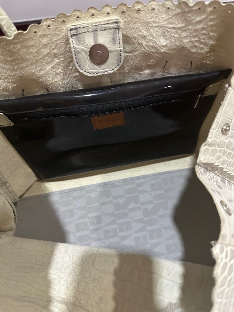 Furla crocodile leather embossed tote bag (Category: Luxury Bags & Wallets) located in Manila. Submitted by onestopboutique (Listing ID 1373997291, Image 3). Description: •100% Authentic •With dust bag •High in appeal and style •This tote from Furla comes crafted from croc-embossed leather and is equipped with dual top handles •An attached brand tag, and gold-tone hardware •The interior is fabric-lined and sized well to hold all your essentials. 