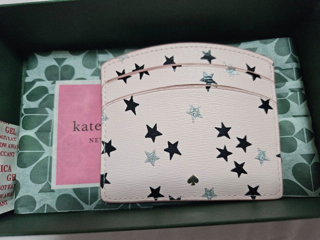(Fast deal $70) Kate Spade Pink Star Card Holder (Category: Garage sale) located in Singapore. Submitted by roseate.love (Listing ID 1375965319, Image 2). Description: Kate Spade card holder. Pink with black and silver stars. Includes multiple card slots. Comes with original box. Compact and stylish..
