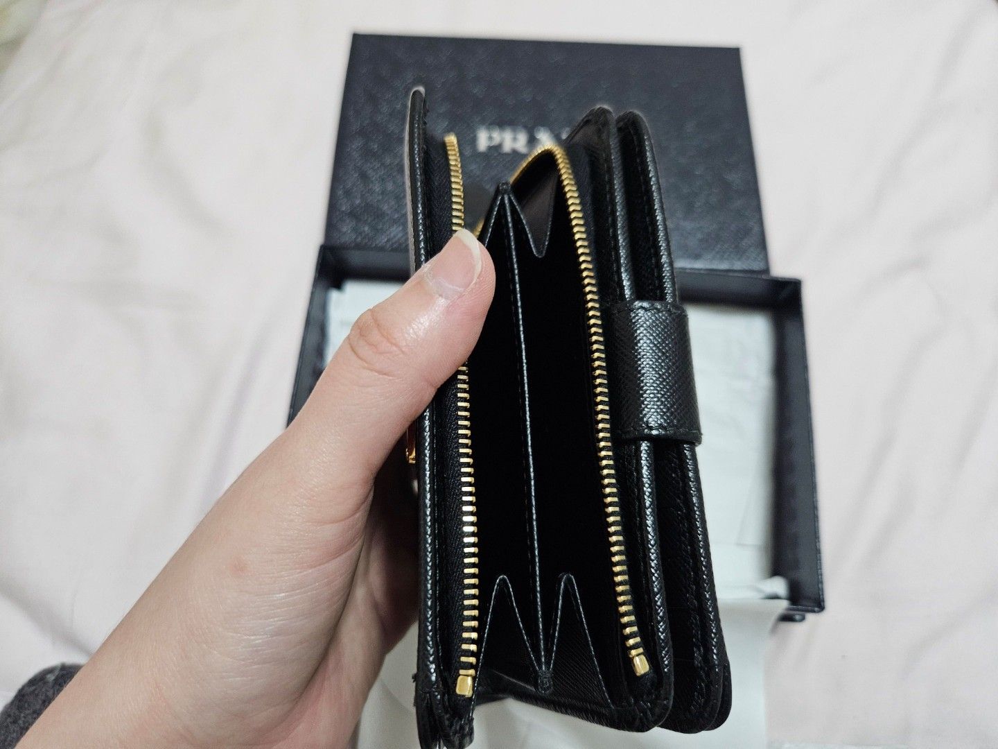 (Fast deal $350) Prada Saffiano Leather Zip-Around Wallet (Category: Garage sale) located in Singapore. Submitted by roseate.love (Listing ID 1375968512, Image 2). Description: Authentic Prada Saffiano leather wallet. Features zip closure, card slots, and bill compartment. Includes original box..