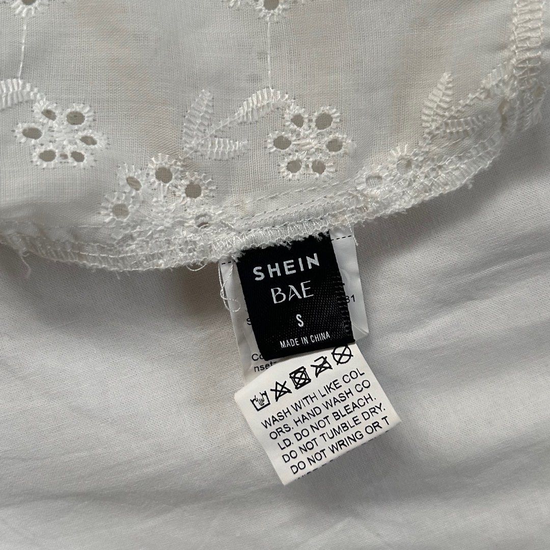 Shein White Eyelet Cottagecore Sleeveless Top (Category: Sleeveless) located in Cavite. Submitted by kydeclutter (Listing ID 1375886716, Image 3). Description: - Worn twice - Such a cute summery and cottage core top - Small make up stains are visible but can be handwashed to remove it - Originally bought for ₱300+ - RFS: A bit loose on me on the chest area haha .