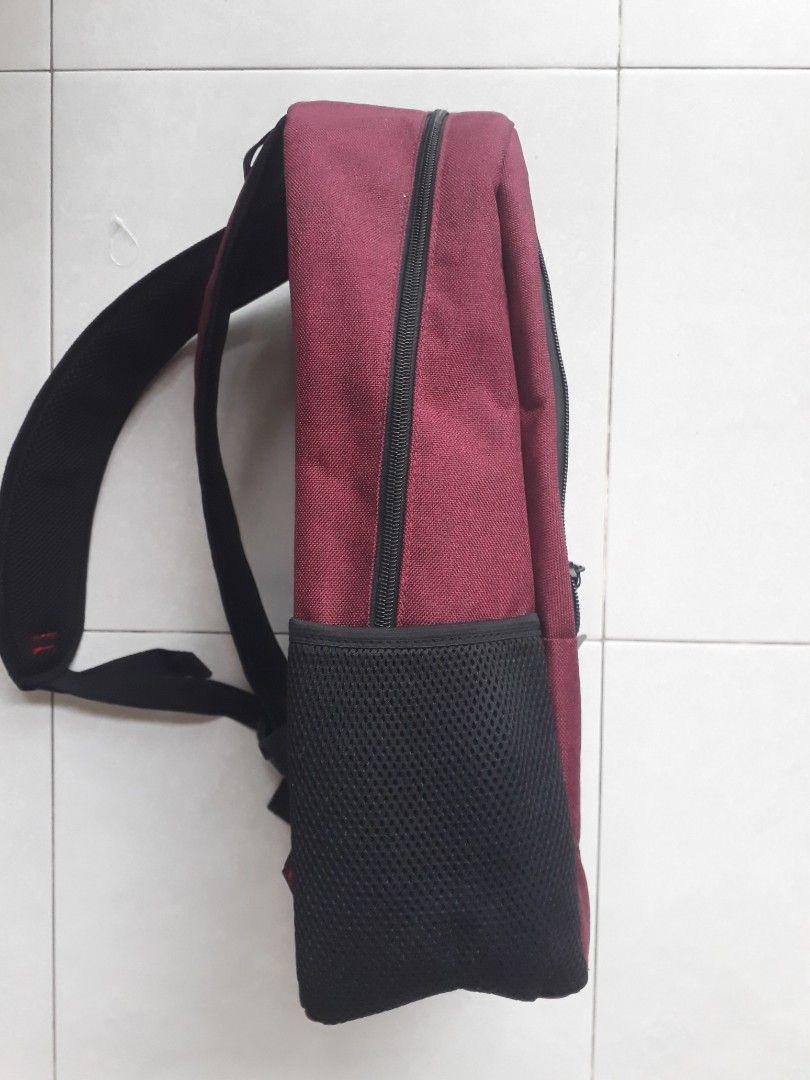 Alain Delon Maroon Backpack (Category: Bags & Wallets) located in Singapore. Submitted by tomtec70 (Listing ID 1376106215, Image 3). Description: Received as gift but i already have a backpack. Nice maroon colour with 3 zip pockets and 3 side pouches. Cushion back with comfortable shoulder straps and holder to secure your backpack to luggage handle when extended. Stylish and professional. Selling in Isetan for $79.90 Self collect in Sengkang unde