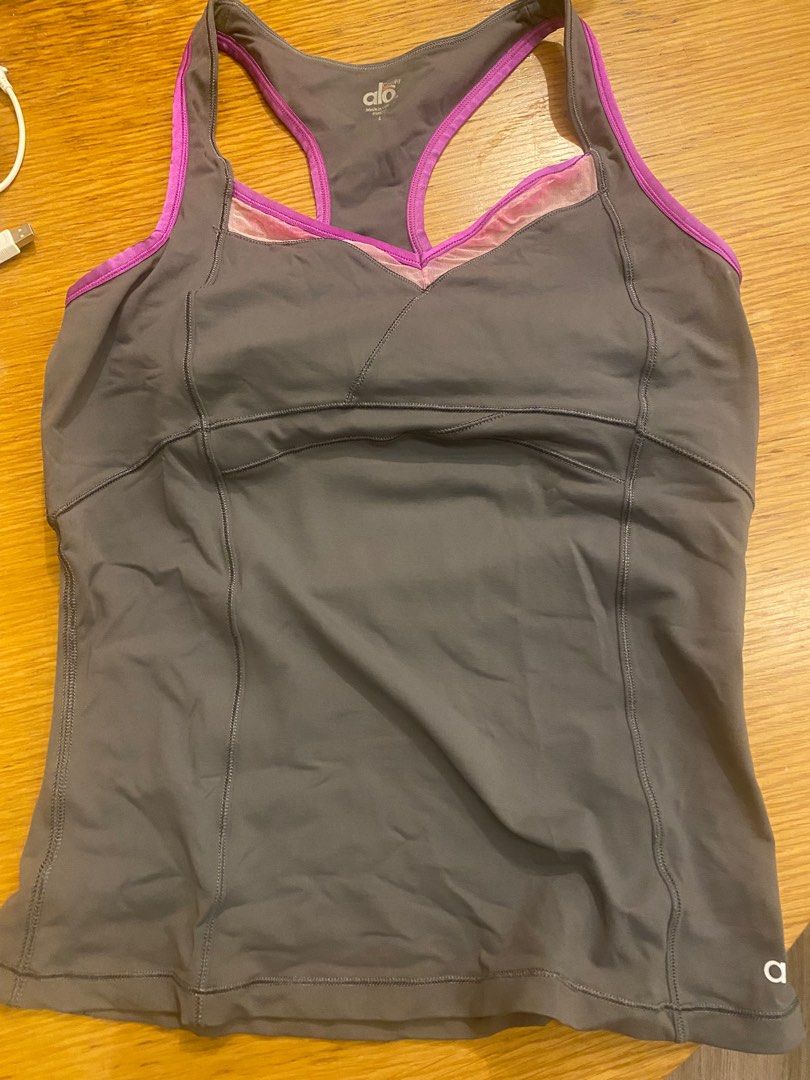 ALO yoga / sport top with built in bra (Category: Activewear) located in Taguig. Submitted by allthingspinkandpurple (Listing ID 1376162801, Image 1). Description: ALO yoga top. Slightly used but with the following issues : 1) the magenta color faded into the net/clear part of the top (from washing machine wash), and 2) I threw out the bra pads. The built in bra is very good - holds really well, and fully covers. .