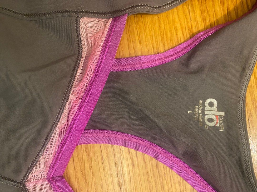 ALO yoga / sport top with built in bra (Category: Activewear) located in Taguig. Submitted by allthingspinkandpurple (Listing ID 1376162801, Image 3). Description: ALO yoga top. Slightly used but with the following issues : 1) the magenta color faded into the net/clear part of the top (from washing machine wash), and 2) I threw out the bra pads. The built in bra is very good - holds really well, and fully covers. .