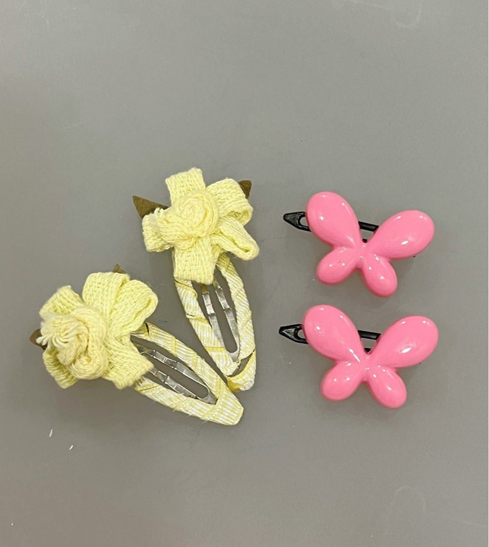 Children hair clips (2 sets) (Category: Babies & Kids Fashion) located in Singapore. Submitted by white_blue_sky (Listing ID 1376121452, Image 1). Description: one set of pink butterfly clips one set of yellow flower clips.