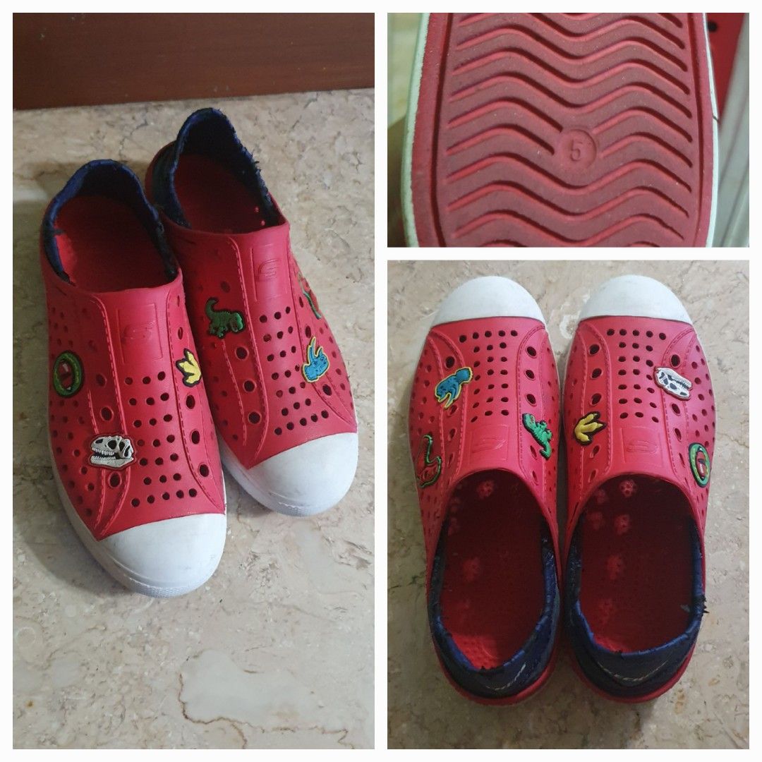 Kids' Red Dinosaur Slip-On Shoes Size 5 (Category: Babies & Kids Fashion) located in Singapore. Submitted by yung123 (Listing ID 1376181456, Image 1). Description: Red slip-on shoes with dinosaur and fun designs. Size 5. Easy to wear. skechers foamies guzman big kid size 5, measure abt 25cm.