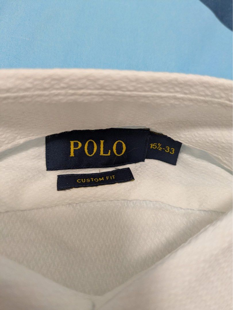 Polo Ralph Lauren Custom Fit Shirt 15 1/2-33 White (Category: Tshirts & Polo Shirts) located in Singapore. Submitted by .a.j. (Listing ID 1376134339, Image 2). Description: Men's Polo Ralph Lauren Custom Fit shirt in size 15 1/2-33. The shirt is white with a classic button-down collar. It features the iconic Polo Ralph Lauren pony logo embroidered on the chest. The fabric appears to be a breathable cotton blend..