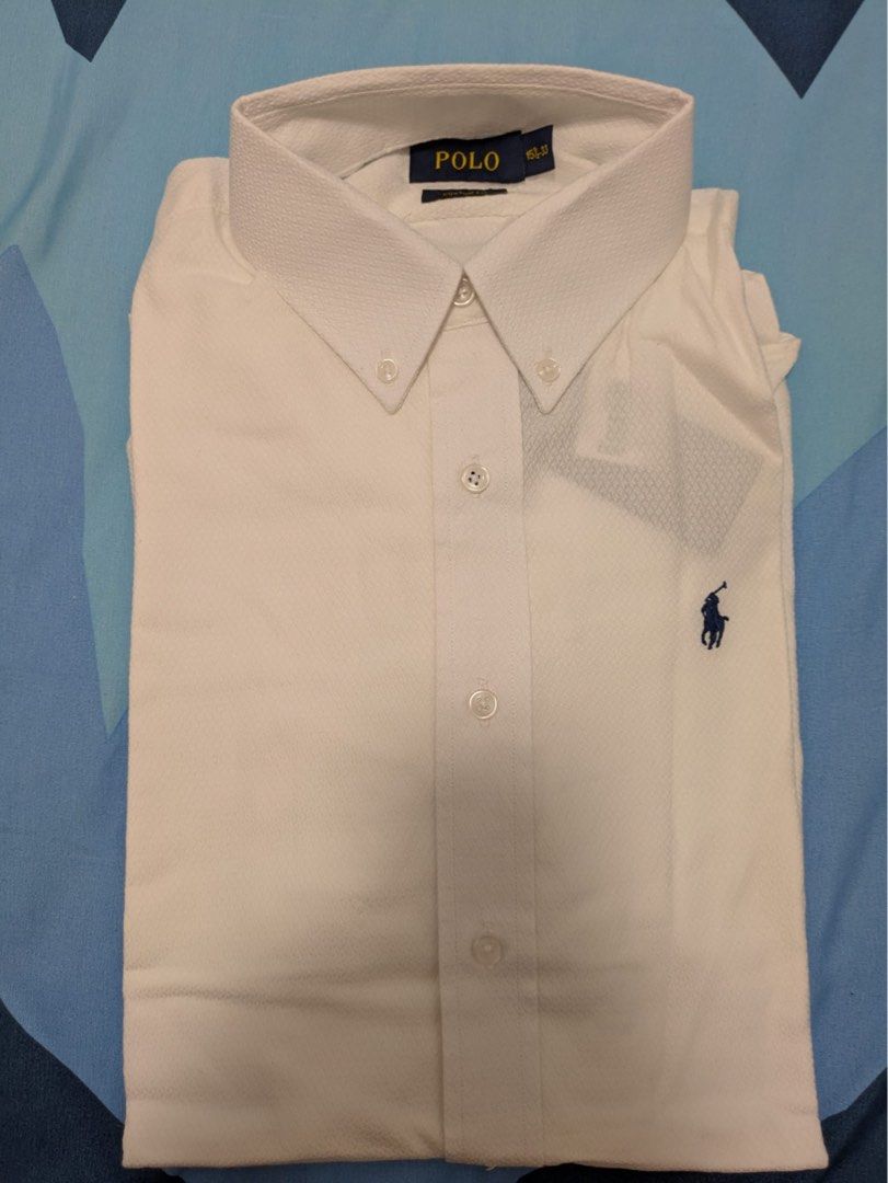 Polo Ralph Lauren Custom Fit Shirt 15 1/2-33 White (Category: Tshirts & Polo Shirts) located in Singapore. Submitted by .a.j. (Listing ID 1376134339, Image 1). Description: Men's Polo Ralph Lauren Custom Fit shirt in size 15 1/2-33. The shirt is white with a classic button-down collar. It features the iconic Polo Ralph Lauren pony logo embroidered on the chest. The fabric appears to be a breathable cotton blend..