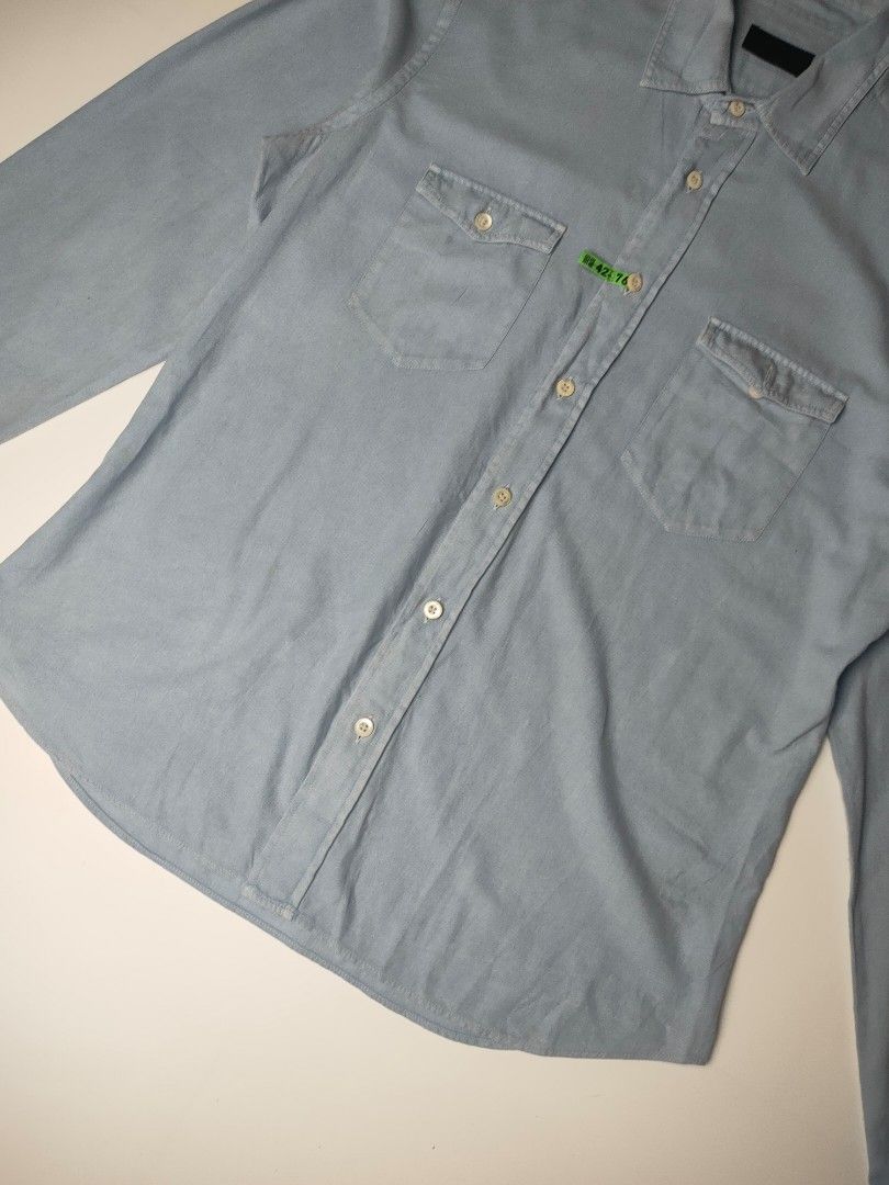 Prada Western-Style Denim Shirt (Category: Coats, Jackets and Outerwear) located in Manila. Submitted by 1702finest (Listing ID 1376153474, Image 3). Description: Prada Western-Style Denim Shirt Light blue snap-button shirt featuring dual chest pockets and subtle Prada tag detail on the placket. Measurements (inches): Fits Medium Pit to pit: 21 Shoulder: 18 Length: 28.5 Sleeve: 27 Hem: 21 Made in Italy. 🔸 Note: Minor stain on the right shoulder 