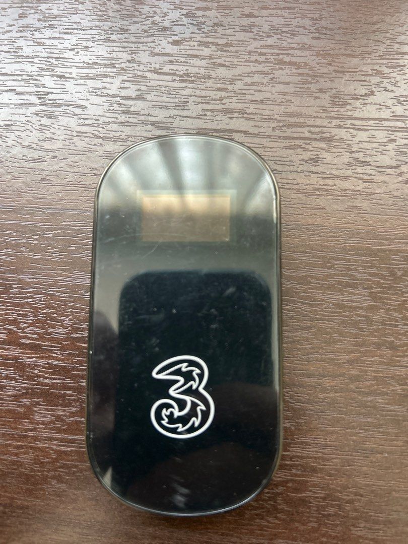 3 Mobile Wifi Modem (Category: Networking) located in Singapore. Submitted by yonakho (Listing ID 1376246445, Image 1). Description: Three mobile wifi modem. Compact and portable design. Ideal for travel or use as a backup internet connection. The device is black and features the Three logo. It has a sleek, oblong shape..