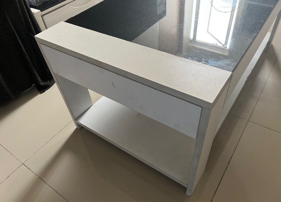 Coffee/Center Table (Category: Coffee & Tea Tableware) located in Mandaluyong City. Submitted by pepitomanaloto_777 (Listing ID 1376361662, Image 2). Description: Center/Coffee Table Used condition Top Glass Tinted ✅ No Cracks or damage sa main glass ✅ With open storage at the bottom ✅ Honest issue some discoloration (Pekas) on some parts. Not noticeable naman and doesnt affect the quality of the table. U can repaint it if you want. But the table