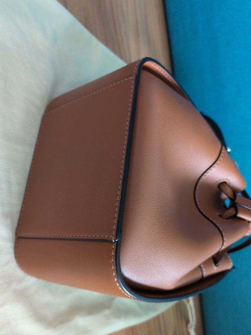 Loewe Mini Hammock Bag - Tan (Category: Bags & Wallets) located in Singapore. Submitted by supernovasg (Listing ID 1376316543, Image 3). Description: Condition: Like new Colour: Tan Material: leather exterior & herringbone cotton canvas interior Dimensions: approx L10.5 x W15 x H 19 cm excluding handles. Comes with receipt, care booklet, dust bag, box and paper bag (if I can find it)..