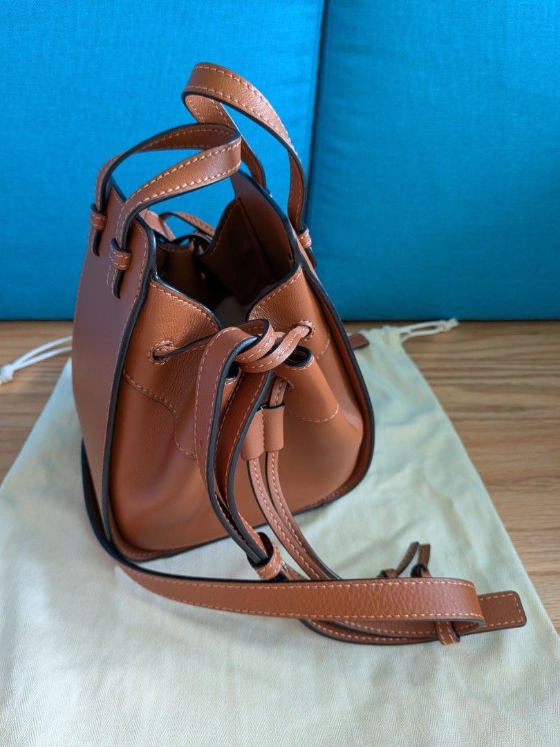 Loewe Mini Hammock Bag - Tan (Category: Bags & Wallets) located in Singapore. Submitted by supernovasg (Listing ID 1376316543, Image 2). Description: Condition: Like new Colour: Tan Material: leather exterior & herringbone cotton canvas interior Dimensions: approx L10.5 x W15 x H 19 cm excluding handles. Comes with receipt, care booklet, dust bag, box and paper bag (if I can find it)..