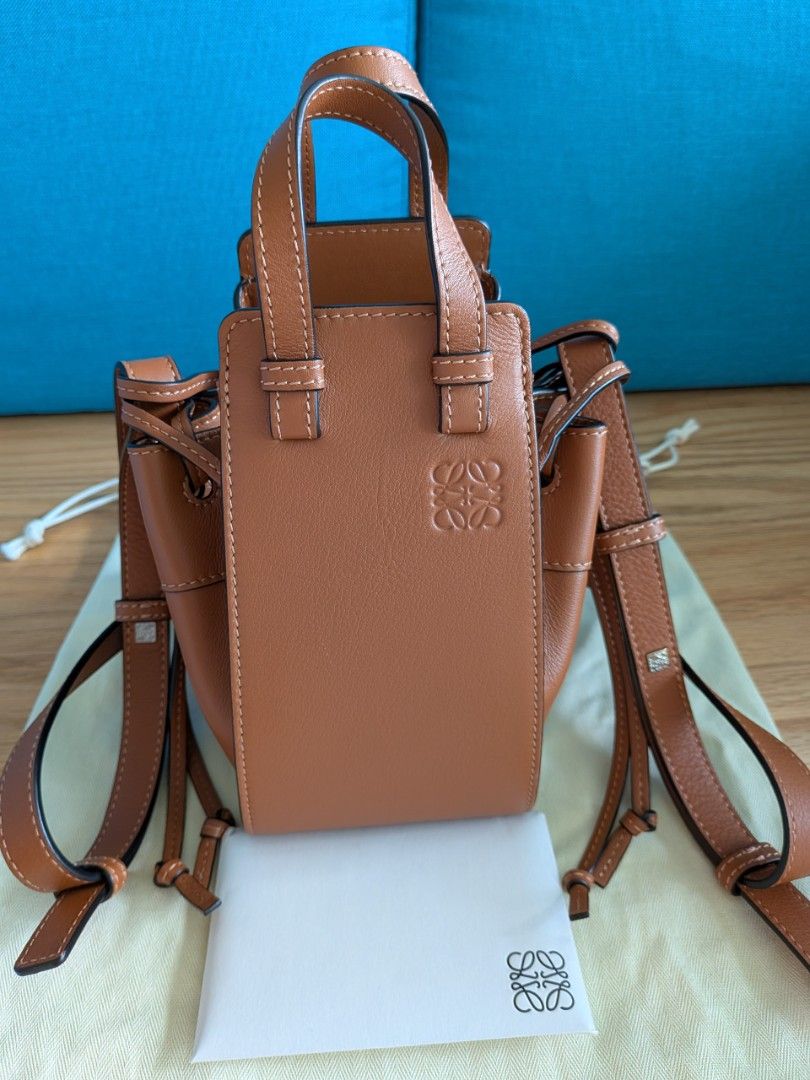 Loewe Mini Hammock Bag - Tan (Category: Bags & Wallets) located in Singapore. Submitted by supernovasg (Listing ID 1376316543, Image 1). Description: Condition: Like new Colour: Tan Material: leather exterior & herringbone cotton canvas interior Dimensions: approx L10.5 x W15 x H 19 cm excluding handles. Comes with receipt, care booklet, dust bag, box and paper bag (if I can find it)..