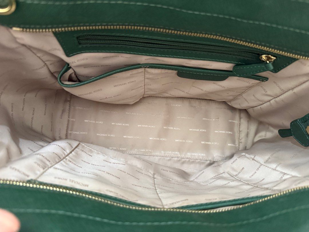Michael Kors Emerald Green Tote Bag (Category: Bags & Wallets) located in Singapore. Submitted by minnize (Listing ID 1376284612, Image 3). Description: Stylish Michael Kors tote bag in a rich emerald green. Features gold-tone hardware and a spacious interior with multiple compartments. Includes a detachable shoulder strap for versatile carrying options. .