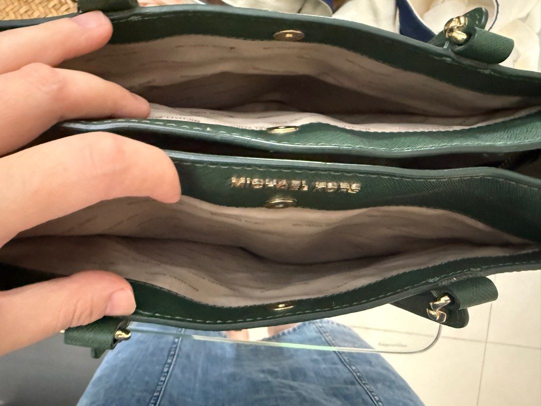 Michael Kors Emerald Green Tote Bag (Category: Bags & Wallets) located in Singapore. Submitted by minnize (Listing ID 1376284612, Image 2). Description: Stylish Michael Kors tote bag in a rich emerald green. Features gold-tone hardware and a spacious interior with multiple compartments. Includes a detachable shoulder strap for versatile carrying options. .