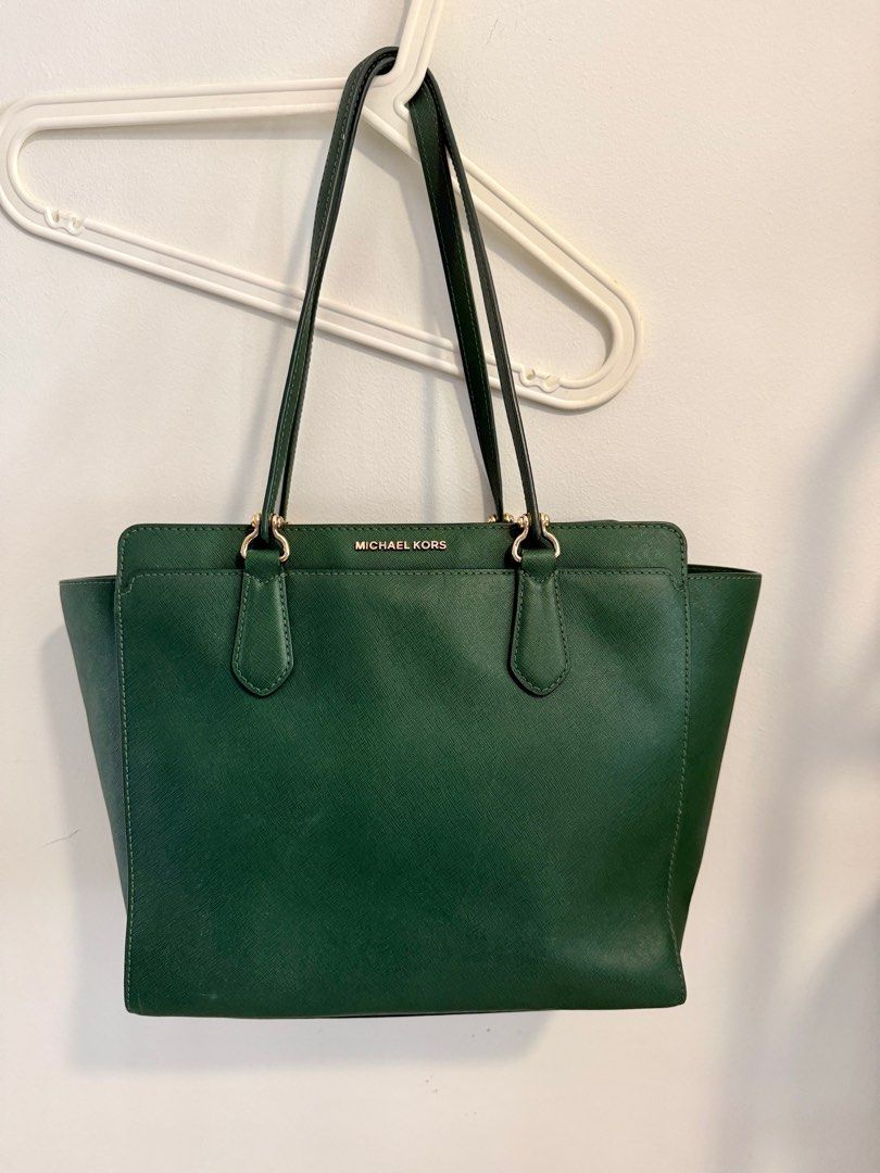 Michael Kors Emerald Green Tote Bag (Category: Bags & Wallets) located in Singapore. Submitted by minnize (Listing ID 1376284612, Image 1). Description: Stylish Michael Kors tote bag in a rich emerald green. Features gold-tone hardware and a spacious interior with multiple compartments. Includes a detachable shoulder strap for versatile carrying options. .