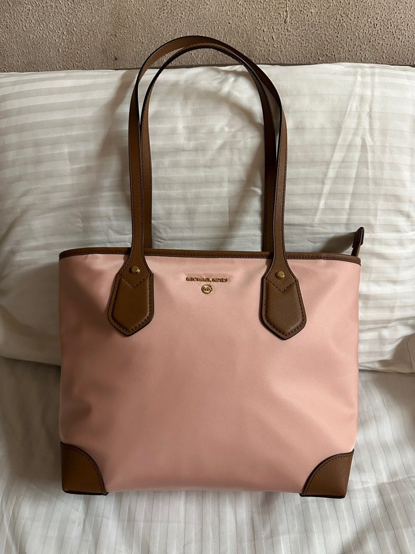 Michael Kors Eva Small Nylon Top Zip Tote (Category: Luxury Bags & Wallets) located in Pateros City. Submitted by overandout. (Listing ID 1376323655, Image 2). Description: ORIGINAL PRICE: 128 USD (PHP 7,318.02) Brand New With Tags! MICHAEL Michael Kors Eva nylon top zip tote is the perfect size to fit all the essentials you need. Product Features 14W x 9.5 H x 4.5D Material: Light Weight Gabardine; Trim: Saffiano Leather; Lining: 100% Polyester 