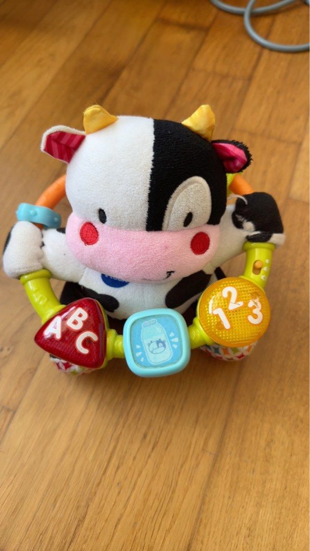 VTech Baby Cow Rattle Toy with Numbers and ABC (Category: Infant Playtime) located in Singapore. Submitted by daveholmes (Listing ID 1376296489, Image 1). Description: VTech baby cow rattle toy. Features a soft cow plush, ABCs, numbers, and sound effects. Good condition..