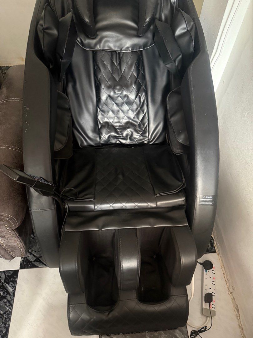 Massage Chair with Heat and Multiple Modes (Category: Massage Devices) located in Singapore. Submitted by dhiren_sks (Listing ID 1376519879, Image 3). Description: Enjoy a relaxing massage at home with this full-body massage chair. Features include kneading, rolling, and pressure massage modes, adjustable intensity, heat function, and multiple program settings. The chair is black PU leather with a modern design. It has a user-friendly remote cont