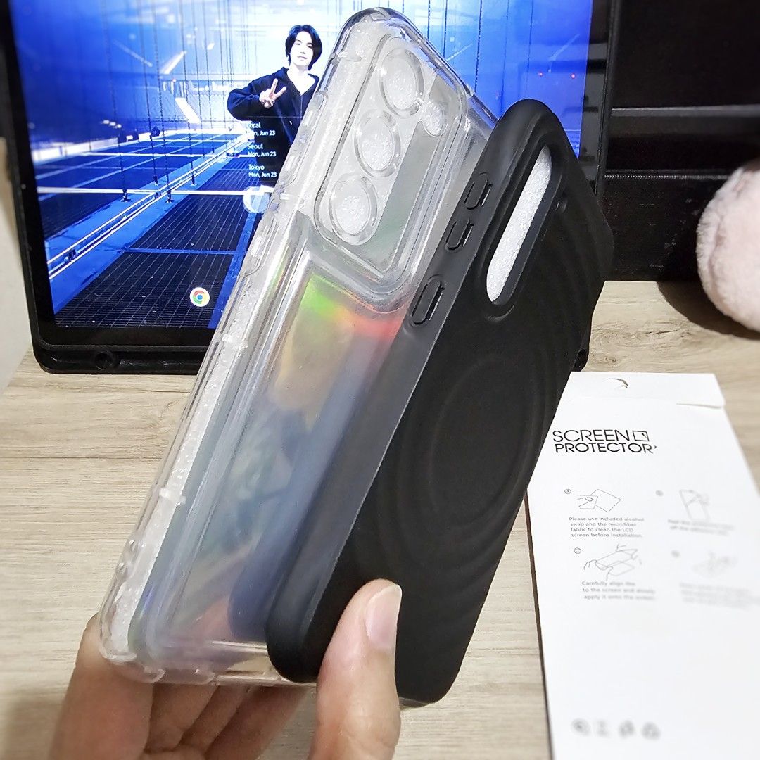 S23 phone cases (Category: Cases & Sleeves) located in Makati City. Submitted by randomelle (Listing ID 1376527021, Image 3). Description: Available while posted RFS changed phone Php100 - (1)black ripple case, magnetic and matte: no damage or peeling, 90% clean, need constant polishing but really loved this one. Php120 - (1)clear with unused holo non-stick film: slightly used, quite new, no damage, 95% smooth..