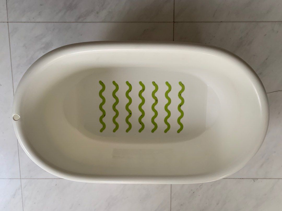 Baby Bath Tub with Non-Slip Mat (Category: Bathtub & Bath Accessories) located in Singapore. Submitted by benedictecha (Listing ID 1376734684, Image 1). Description: Adorable baby bathtub in off-white with a built-in green non-slip mat. Oval-shaped tub is perfect for newborns and infants. Lightweight and easy to clean. Ideal for comfortable and safe bathing..