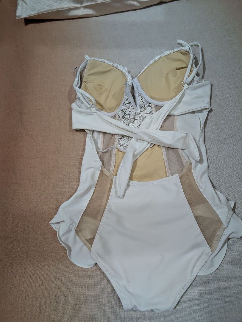 Rare white one piece swimsuit (Category: Bikinis & Swimsuits) located in Imus. Submitted by kmoort (Listing ID 1376654564, Image 2). Description: medium on tag can fit to small and medium size padded push up bar with adjustable strap see through skin tone mesh details on both side no photos when worn color may vary due to light conditions sf not included.
