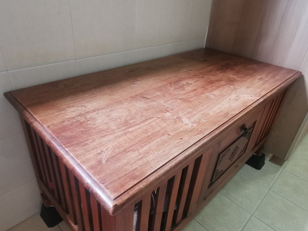 solid wood coffee table (Category: Tables & Sets) located in Singapore. Submitted by bvnymeng (Listing ID 1376655490, Image 1). Description: Beautiful wooden storage chest with intricate carvings. Features a lift-up top and a small drawer with ornate detailing. Made of solid wood with a rich reddish-brown finish. The chest sits on four small, dark-colored feet. Ideal as a coffee table or storage solution..