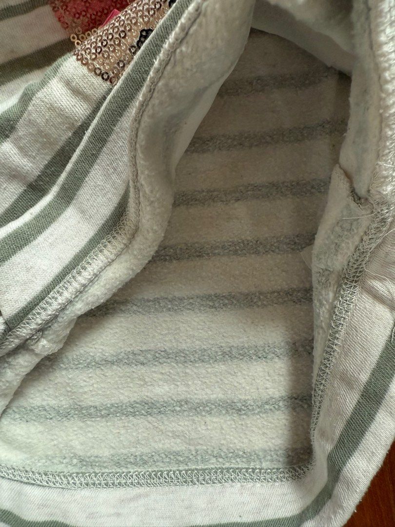 (9-12M) H&M Striped Bunny Sweater (Category: Babies & Kids Fashion) located in Singapore. Submitted by planet.stars (Listing ID 1376907434, Image 3). Description: Adorable H&M sweater featuring a cute bunny design with sequins and a pink bow. The sweater has a striped pattern and is made of a soft material. It's in great condition, perfect for your little one!.