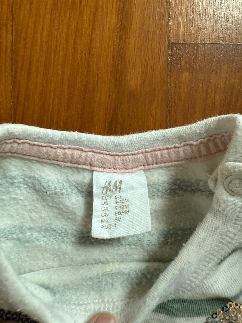 (9-12M) H&M Striped Bunny Sweater (Category: Babies & Kids Fashion) located in Singapore. Submitted by planet.stars (Listing ID 1376907434, Image 2). Description: Adorable H&M sweater featuring a cute bunny design with sequins and a pink bow. The sweater has a striped pattern and is made of a soft material. It's in great condition, perfect for your little one!.
