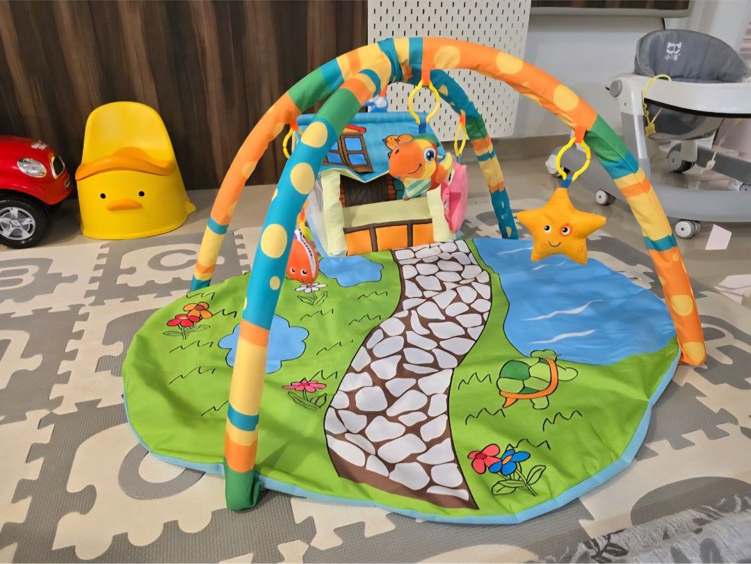 Baby Play Gym with Hanging Toys (Category: Infant Playtime) located in Singapore. Submitted by sim_ch (Listing ID 1376957812, Image 1). Description: Strictly self collection only. This colorful play gym features a soft mat with a whimsical design. Includes hanging toys like a star, lion, and owl to entertain your little one. Perfect for tummy time and playtime..