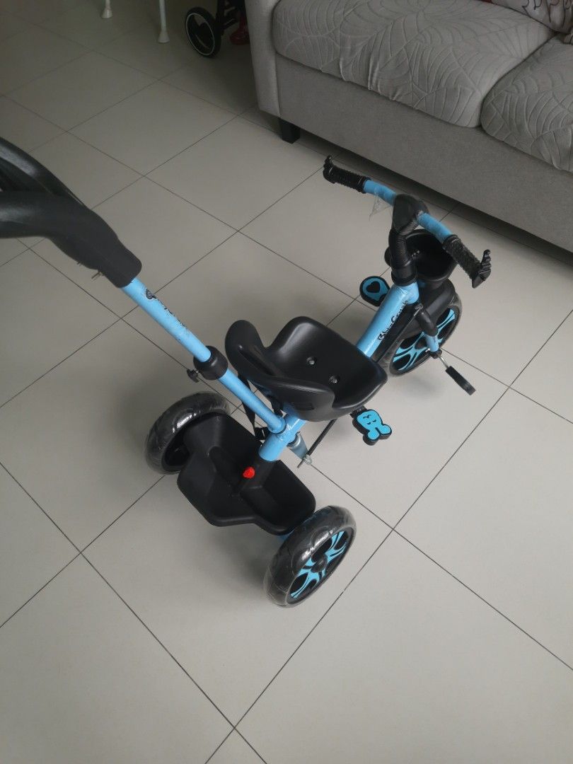 Baby Tricycle - Blue (Category: Other Babies Going Out Needs) located in Singapore. Submitted by shiv.st (Listing ID 1376906914, Image 3). Description: This children’s bicycle was received as a gift and used only twice indoors. It’s in excellent, like-new condition, with a parent control handle for added safety and guidance. Note : "The front wheel is slightly bent as shown in pic(likely from storage), but the bike is otherwise in perfect conditi