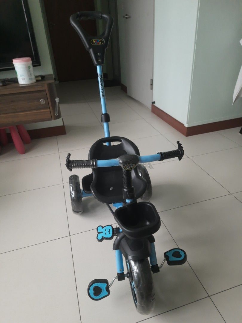 Baby Tricycle - Blue (Category: Other Babies Going Out Needs) located in Singapore. Submitted by shiv.st (Listing ID 1376906914, Image 1). Description: This children’s bicycle was received as a gift and used only twice indoors. It’s in excellent, like-new condition, with a parent control handle for added safety and guidance. Note : "The front wheel is slightly bent as shown in pic(likely from storage), but the bike is otherwise in perfect conditi