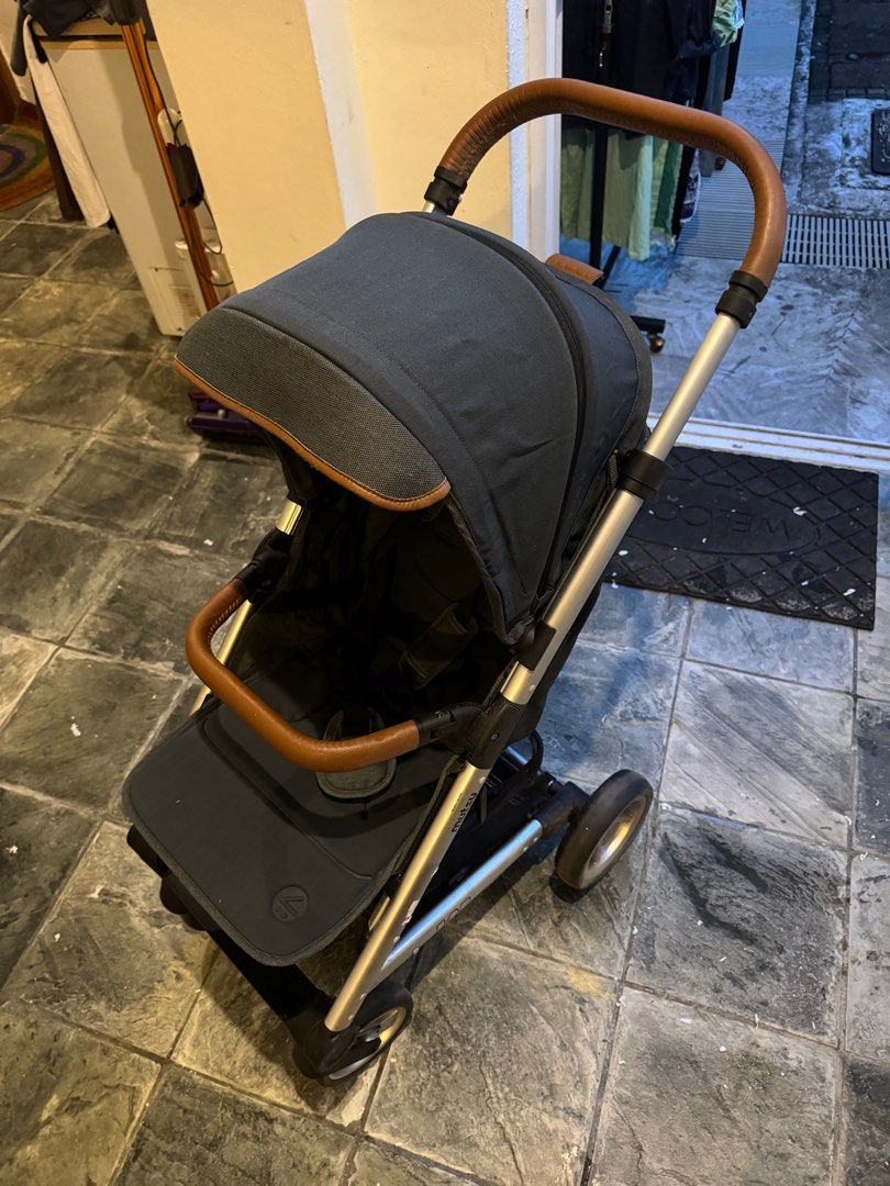Mutsy Nexo Stroller - Leisure River (Category: Strollers) located in Singapore. Submitted by muss_bb (Listing ID 1376933108, Image 1). Description: Used Mutsy Nexo stroller in good condition. Features a dark blue canopy and brown leather-look handles. Includes a storage basket. Perfect for everyday use. Please see photos for details. Nexo features • Weight: 9.5 kg • Seat: 3.5 kg • Chassis: 6 kg • Chassis: 74 cm 101 cm 51 cm • Folded chassis: 65 c