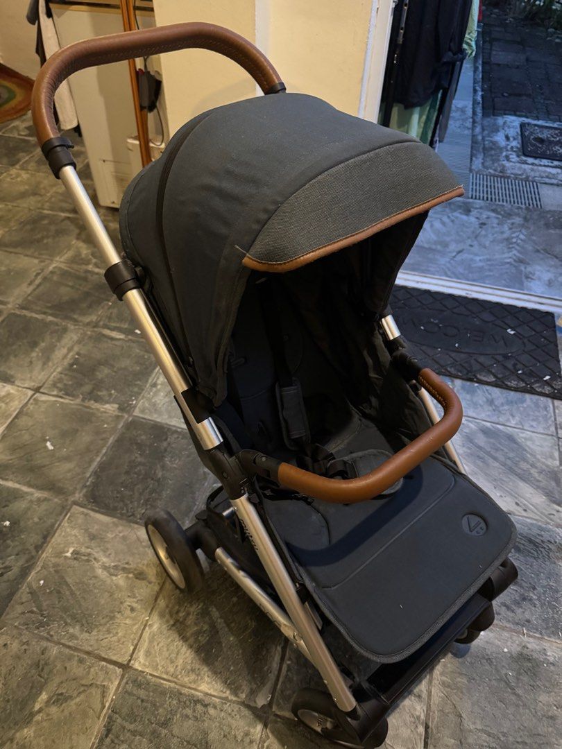 Mutsy Nexo Stroller - Leisure River (Category: Strollers) located in Singapore. Submitted by muss_bb (Listing ID 1376933108, Image 2). Description: Used Mutsy Nexo stroller in good condition. Features a dark blue canopy and brown leather-look handles. Includes a storage basket. Perfect for everyday use. Please see photos for details. Nexo features • Weight: 9.5 kg • Seat: 3.5 kg • Chassis: 6 kg • Chassis: 74 cm 101 cm 51 cm • Folded chassis: 65 c