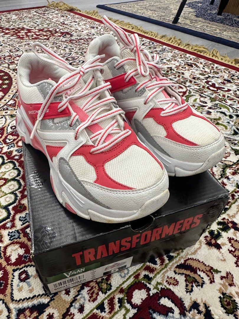Skechers Stamina V3 Transformers Sneakers - US 5 (Category: Babies & Kids Fashion) located in Singapore. Submitted by dood30 (Listing ID 1376931892, Image 1). Description: Lightly used Skechers Stamina V3 Transformers sneakers in US size 5. Features a white and pink color scheme. The shoes come with the original box. The soles show signs of wear. .