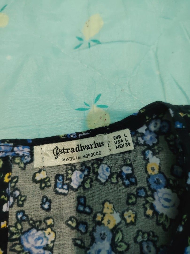 Stradivarius Midnight Garden Dress (Category: Dresses) located in Panabo. Submitted by prettythriftedthings (Listing ID 1377005633, Image 2). Description: Turn heads in this charming black floral dress by Stradivarius! Featuring delicate blue and yellow blooms, puff sleeves, and a relaxed, tiered silhouette, this dress is perfect for a breezy day out or a casual date night. Made with soft, flowy fabric that is comfy, stylish, and easy to wear..