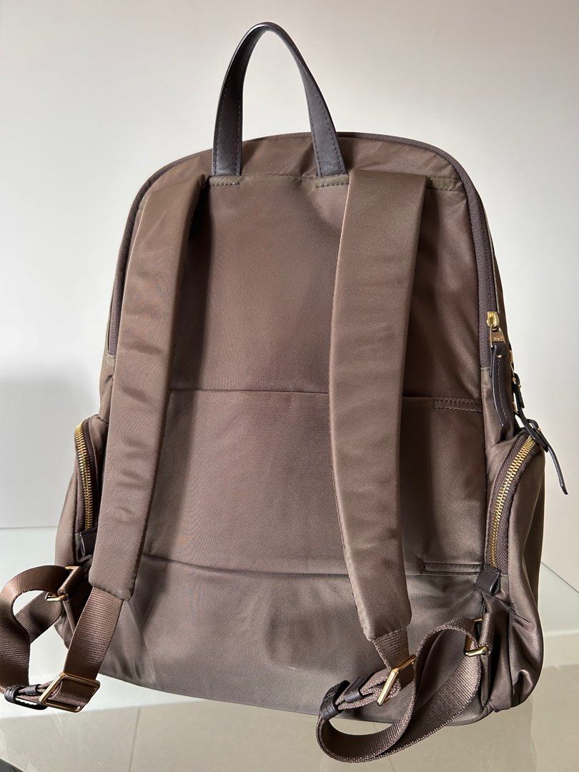 Authentic Tumi backpack (Category: Backpacks) located in Petaling Jaya. Submitted by missben (Listing ID 1377090355, Image 2). Description: Original Tumi back pack with multiple compartment: two main compartment (one for laptop), two side pocket, one external slot compartment and additional external on the front view of the backpack. This backpack is with trolley luggage sleeve for easy traveling. Defects: slight discoloured near the zip area (se