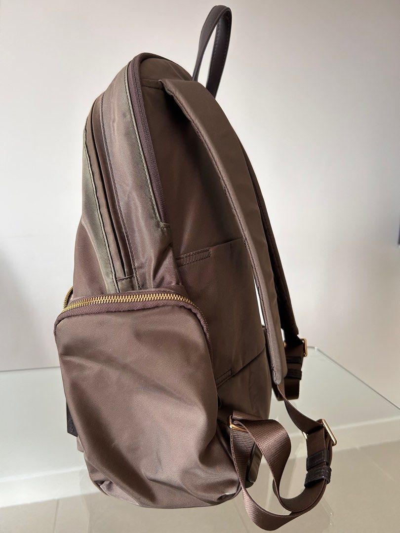 Authentic Tumi backpack (Category: Backpacks) located in Petaling Jaya. Submitted by missben (Listing ID 1377090355, Image 3). Description: Original Tumi back pack with multiple compartment: two main compartment (one for laptop), two side pocket, one external slot compartment and additional external on the front view of the backpack. This backpack is with trolley luggage sleeve for easy traveling. Defects: slight discoloured near the zip area (se